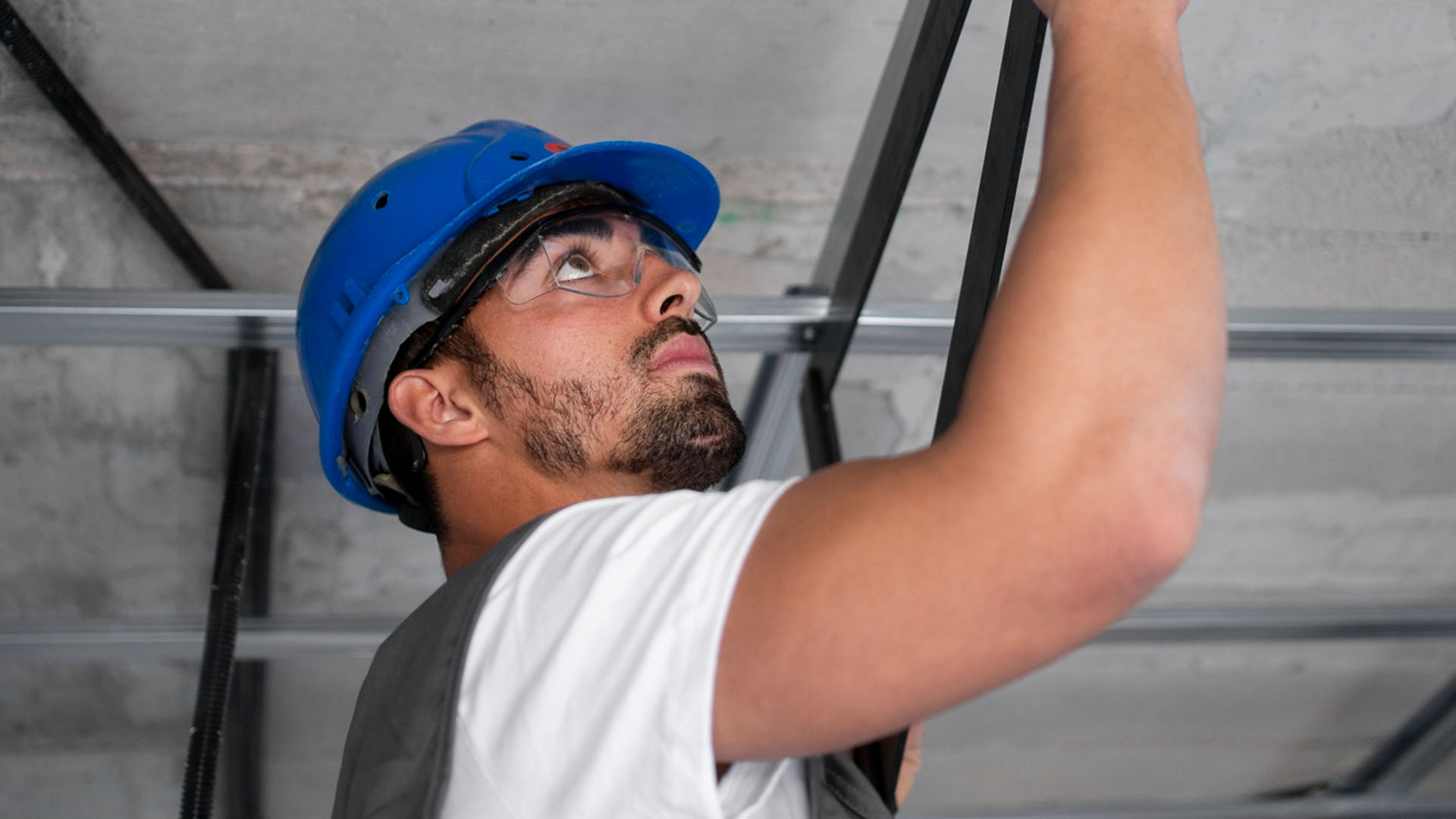 Worker applying sealant to a high concrete joint